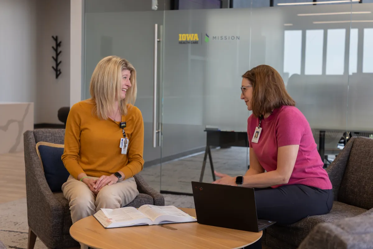 two women discussing clinical trials UI Health Care