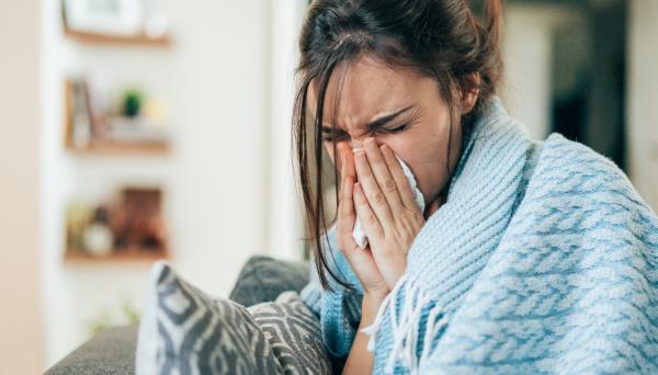 Woman blowing nose